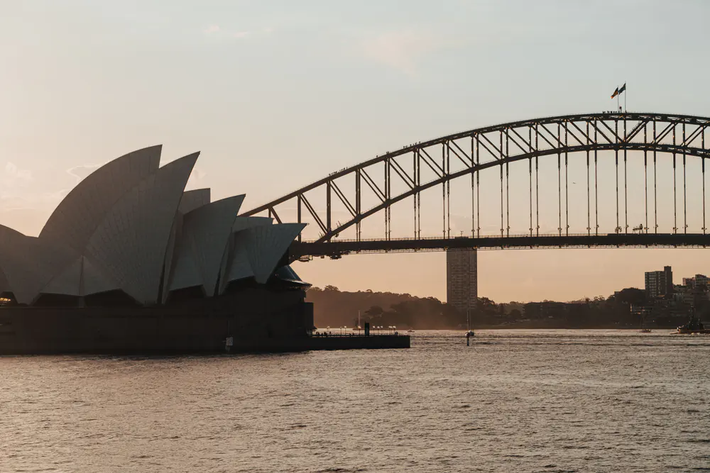 Sydney Opera House and Harbour Bridge across Sydney Harbour at dusk