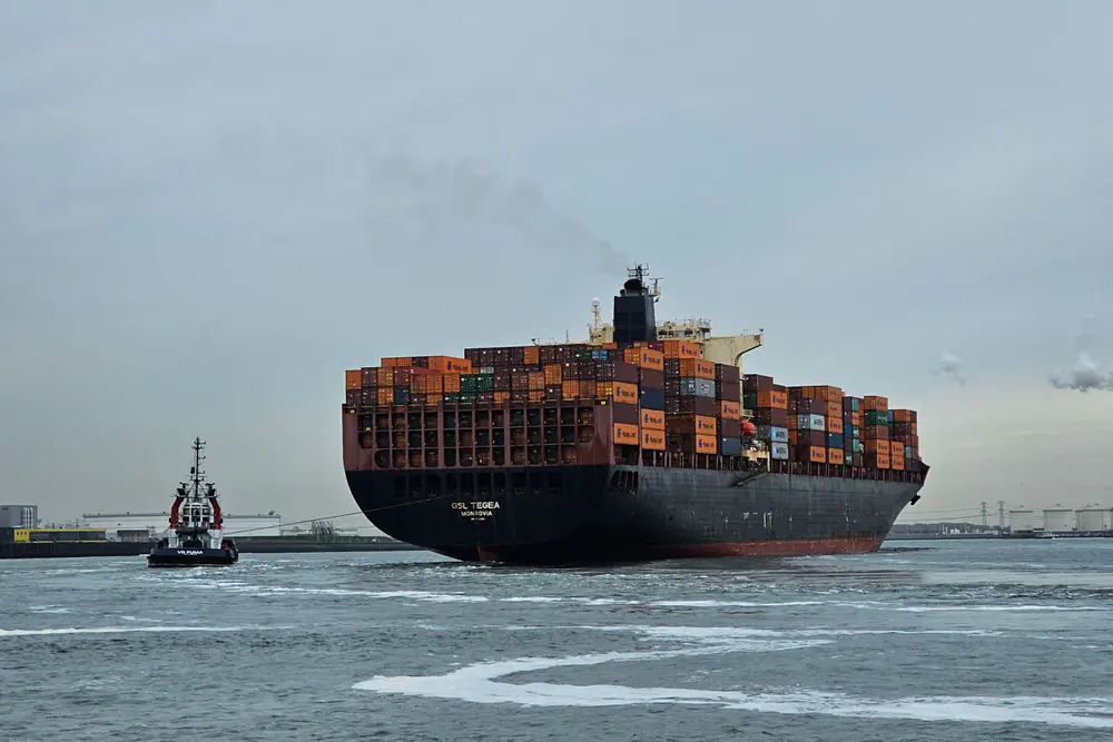 Container ship and tugboat at Maasvlakte Port in Rotterdam