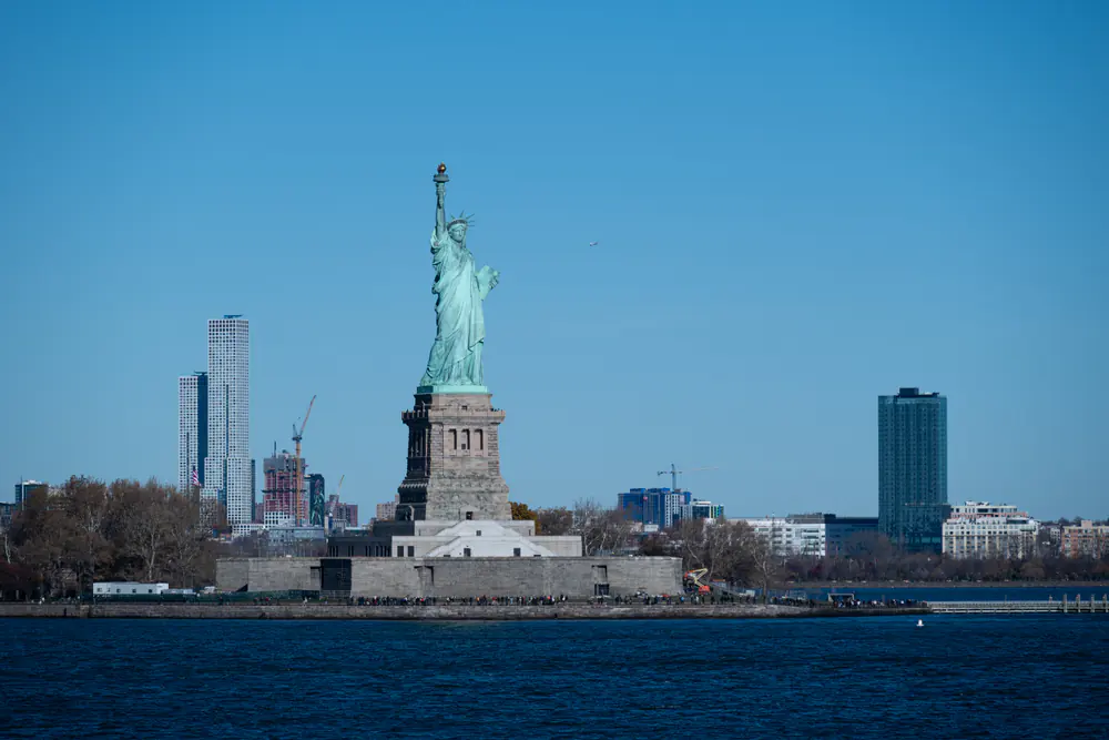 Statue of Liberty in New York Harbor with the city skyline behind